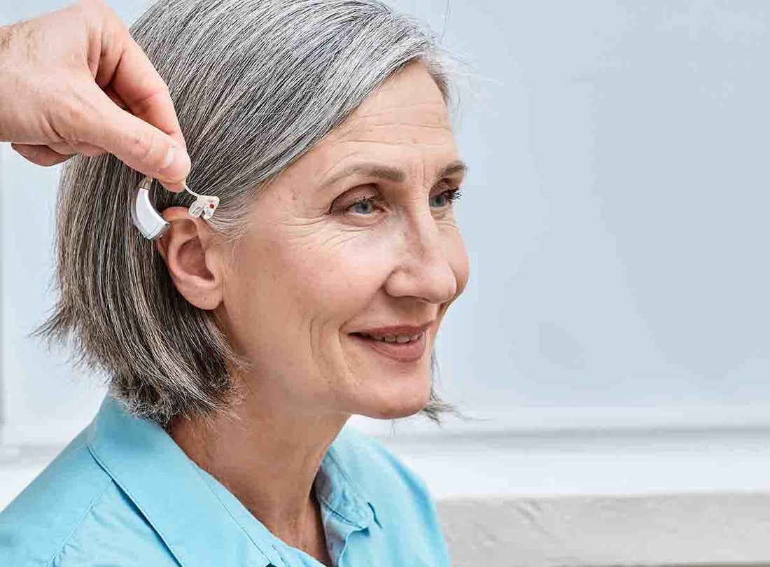 hearing aid fitting on senior woman