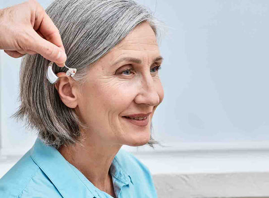 hearing aid fitting on senior woman